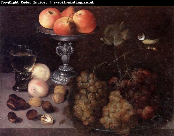 Georg Flegel Still life of grapes on a pewter dish,together with peaches,nuts,a glass roemer and a silver tazza containing apples and pears,and a blue-tit